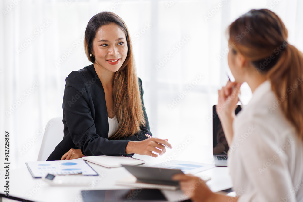 Cropped shot of Asian Business woman diverse coworkers working together in the boardroom, brainstorming, discussing, and analyzing business report strategy collaboration. Cropped shot of Asian Business woman diverse coworkers working together in the boardroom, brainstorming, discussing, and analyzing business report strategy collaboration.