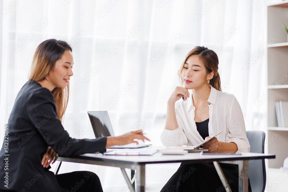Cropped shot of Asian Business woman diverse coworkers working together in the boardroom, brainstorming, discussing, and analyzing business report strategy collaboration. Cropped shot of Asian Business woman diverse coworkers working together in the boardroom, brainstorming, discussing, and analyzing business report strategy collaboration.