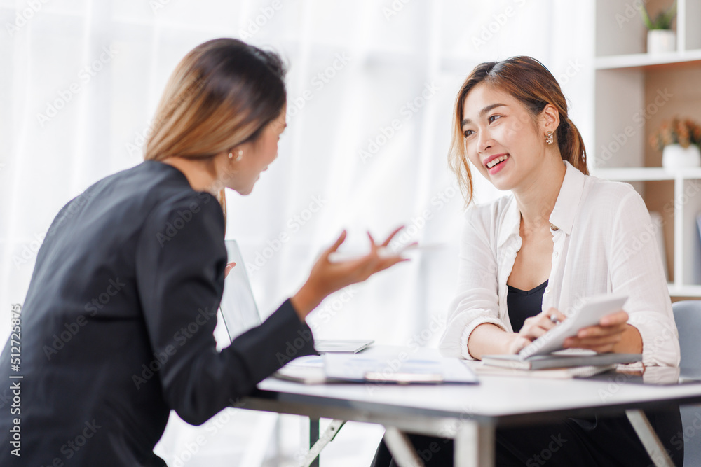 Cropped shot of Asian Business woman diverse coworkers working together in the boardroom, brainstorming, discussing, and analyzing business report strategy collaboration. Cropped shot of Asian Business woman diverse coworkers working together in the boardroom, brainstorming, discussing, and analyzing business report strategy collaboration.