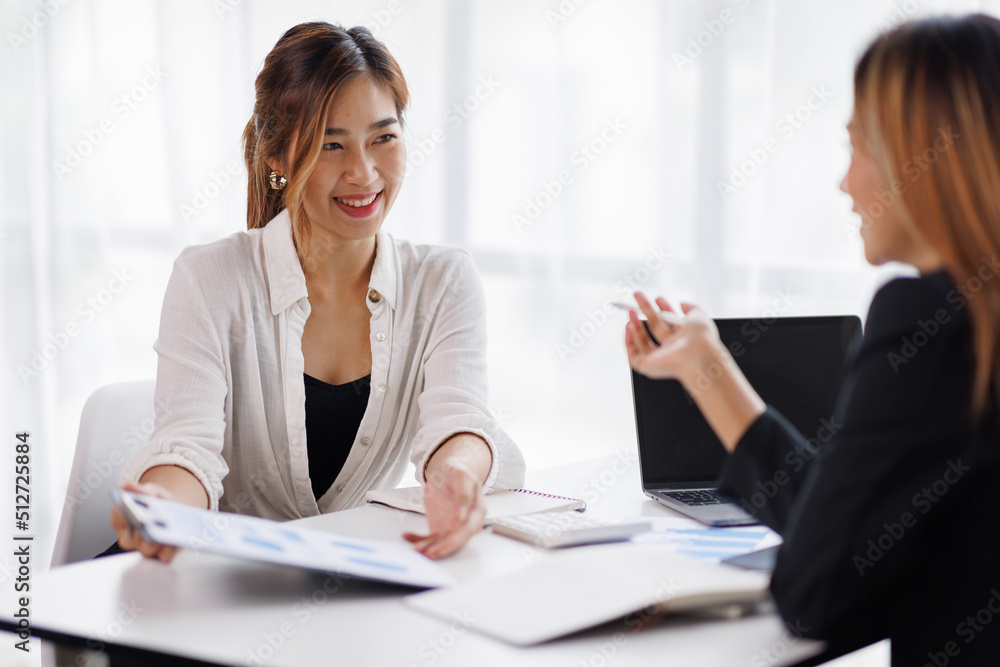 Cropped shot of Asian Business woman diverse coworkers working together in the boardroom, brainstorming, discussing, and analyzing business report strategy collaboration. Cropped shot of Asian Business woman diverse coworkers working together in the boardroom, brainstorming, discussing, and analyzing business report strategy collaboration.