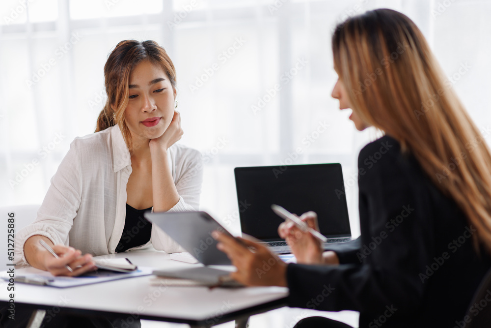 Cropped shot of Asian Business woman diverse coworkers working together in the boardroom, brainstorming, discussing, and analyzing business report strategy collaboration. Cropped shot of Asian Business woman diverse coworkers working together in the boardroom, brainstorming, discussing, and analyzing business report strategy collaboration.
