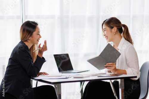 Cropped shot of Asian Business woman diverse coworkers working together in the boardroom, brainstorming, discussing, and analyzing business report strategy collaboration.