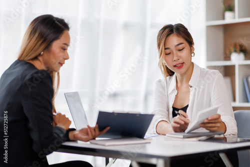 Cropped shot of Asian Business woman diverse coworkers working together in the boardroom, brainstorming, discussing, and analyzing business report strategy collaboration.