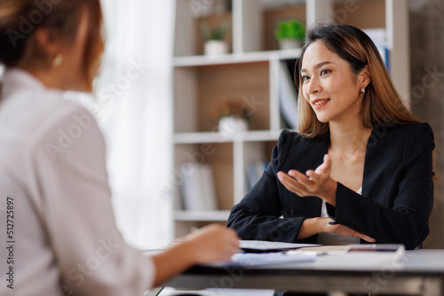 Cropped shot of Asian Business woman diverse coworkers working together in the boardroom, brainstorming, discussing, and analyzing business report strategy collaboration.