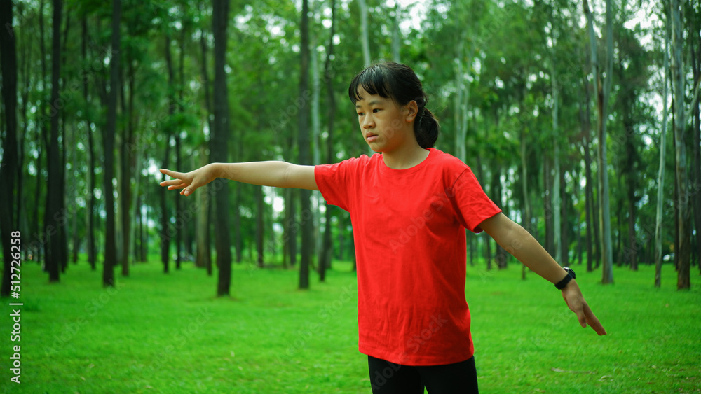 Photograph of a happy yellow-skinned Asian girl relaxing in an outdoor park. Photograph of a happy yellow-skinned Asian girl relaxing in an outdoor park.