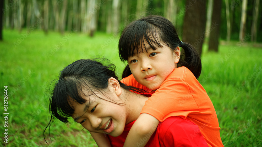 Background image of 2 happy girls smiling cheerfully playing relaxing in the outdoor park. Background image of 2 happy girls smiling cheerfully playing relaxing in the outdoor park.