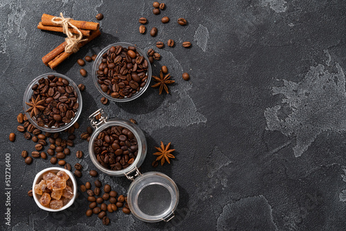 Coffee beans, cinnamon sticks and star anise on dark background top view