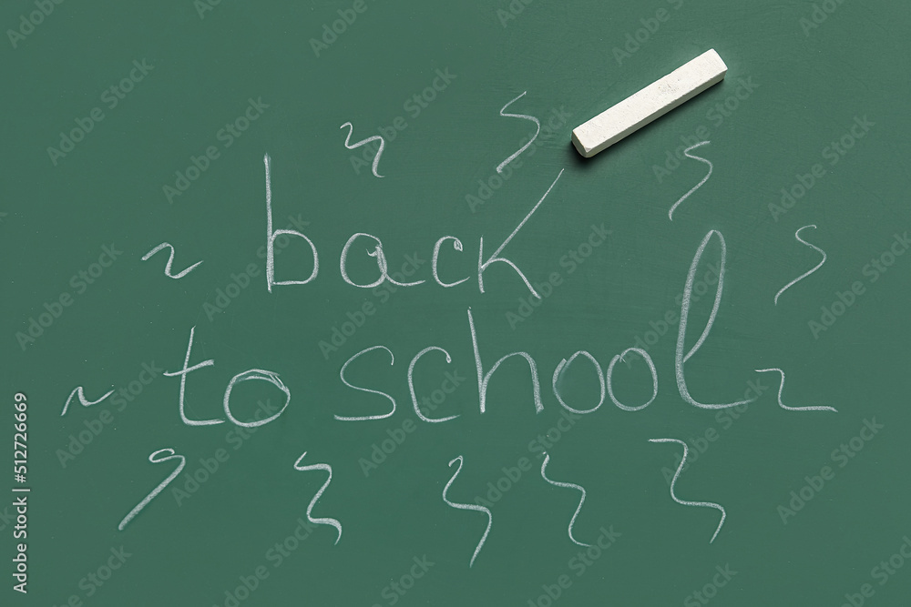 Text BACK TO SCHOOL with chalk on blackboard Text BACK TO SCHOOL with chalk on blackboard