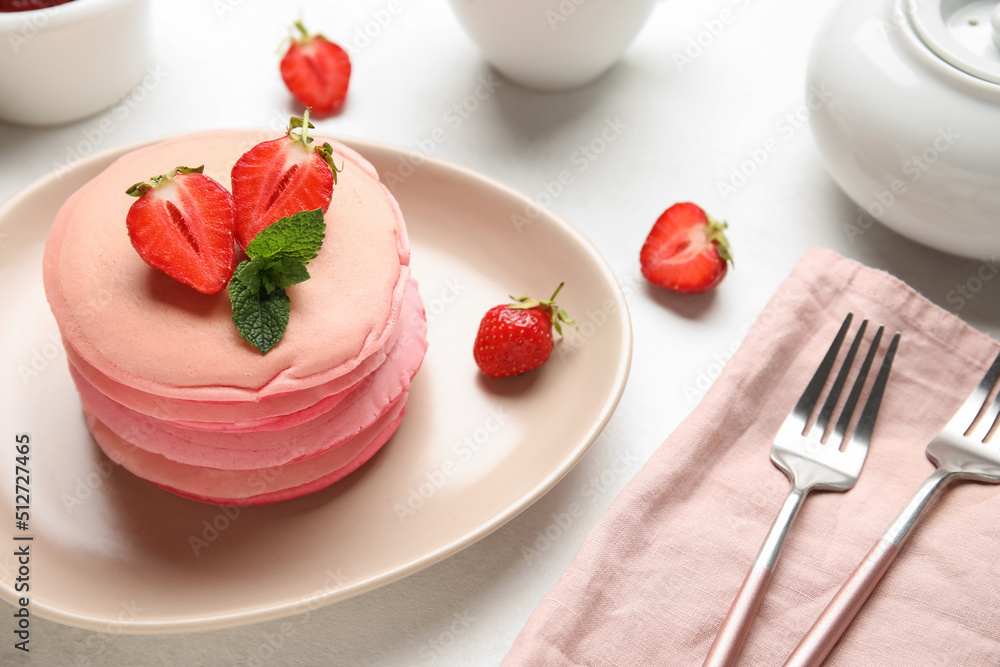 Plate of tasty pancakes with strawberry on table Plate of tasty pancakes with strawberry on table