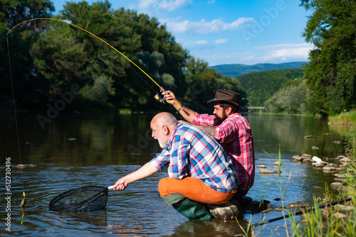 Mature senior man with friend fishing. Summer vacation. Happy cheerful people. Bearded men catching fish. Fisherman with fishing rod. Activity and hobby.