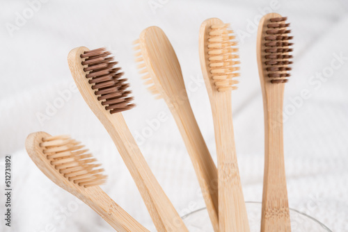 Natural biodegradable eco-friendly wooden toothbrushes with BPA free bristles against white wall background. Natural bath products and zero waste concept  organic dentifrice. Mockup image