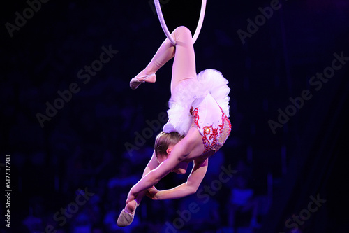 Baby girl aerialist performing under dome of circus. Kyiv, Ukraine photo