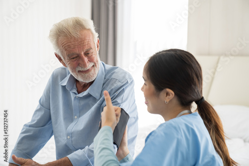 Wallpaper Mural Woman nurse measure the pressure senior man at hospital ward. Asian female nurse caring elderly man patient in room at nursing home. Hospital care and older adults concept Torontodigital.ca
