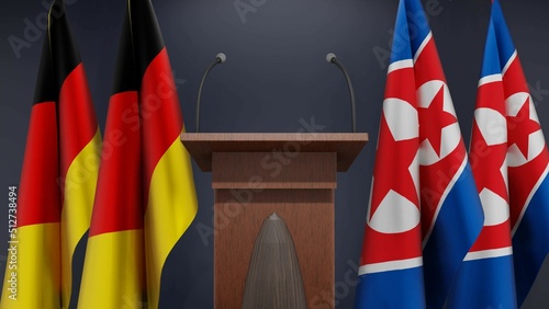 Fototapeta Naklejka Na Ścianę i Meble -  Flags of Germany and North Korea at international meeting or negotiations press conference. Podium speaker tribune with flags and coat arms. 3d rendering
