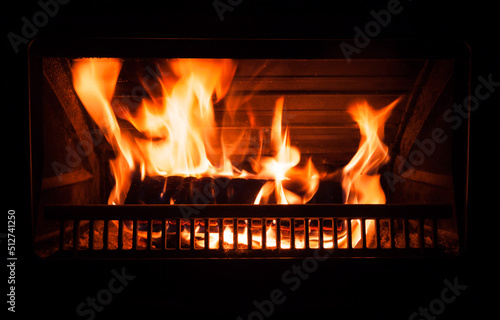 Fire burns in a fireplace at night