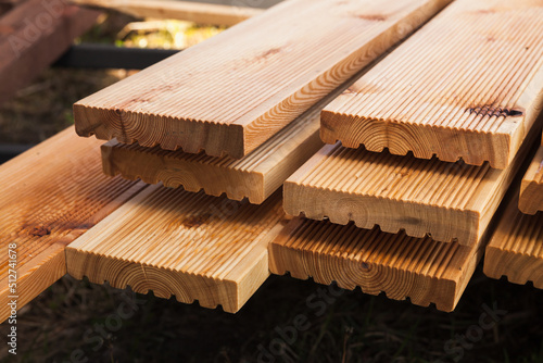 Stacked larch deck boards, close up outdoor photo photo