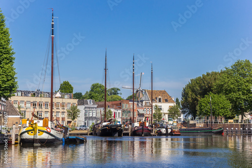 Historic ships and old houses in the harbor of Gouda, Netherlands