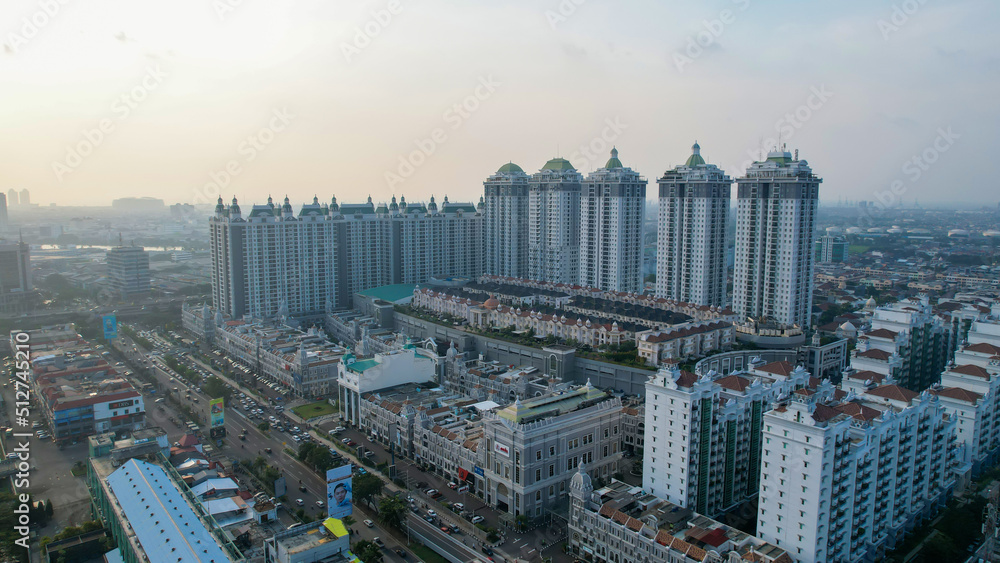 Aerial view of new green urban landscape in the city. Cityscape of a residential area with modern apartment buildings when sunset with noise cloud. 