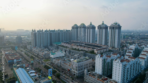 Aerial view of new green urban landscape in the city. Cityscape of a residential area with modern apartment buildings when sunset with noise cloud. 