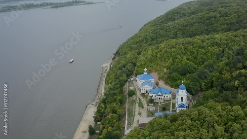 Makaryevsky men Monastery on the banks of the Sviyaga and the Volga River. Christianity and Orthodoxy. A picturesque peaceful place on the water. Forest hills. Pilgrimage and Diocese. Drone footage.  photo