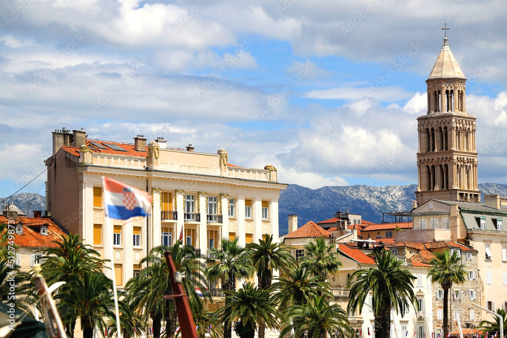 Promenade in Split, Croatia with landmark architecture and sailing boats.
