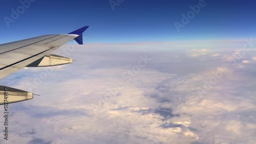 Overwing passenger pov of jet Airbus A320 airplane wing flying high in blue sky. Travel and air transportation concept photo