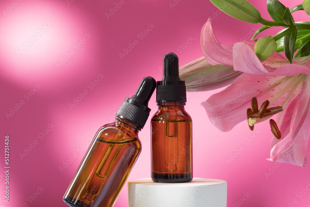 Cosmetic bottles on podium with lily flower and shadow on pink background. Face and body care spa concept. Hyaluronic acid oil, serum with collagen and peptides skin care product Cosmetic bottles on podium with lily flower and shadow on pink background. Face and body care spa concept. Hyaluronic acid oil, serum with collagen and peptides skin care product