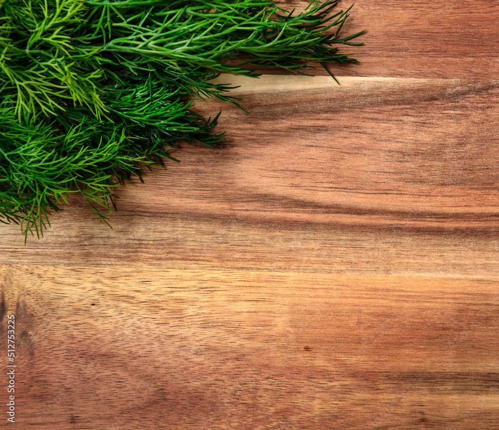 a bunch of green dill on a wooden background with blank space for text, concept of fresh vegetables and healthy food a bunch of green dill on a wooden background with blank space for text, concept of fresh vegetables and healthy food