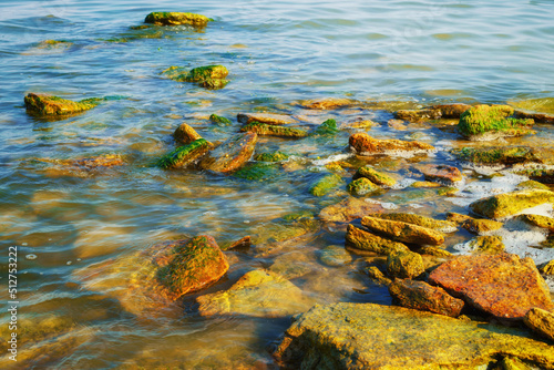 beautiful summer seascape, seashore on a bright day, stones and splashes of waves photo