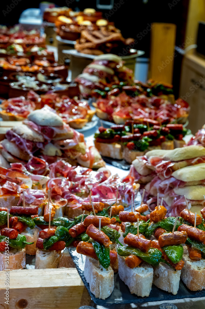 Typical snack of Basque Country and Navarre, pinchos or pinxtos, small piece of bread with different toppings, served in bar, Bilbao, Spain