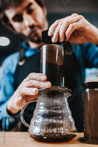 The work of a barista in a cafe close-up - the stages of preparing aromatic coffee - the process of work