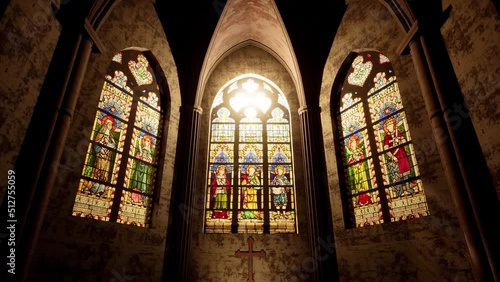 The light of the sun beaming in through the stained glass windows of a Church. photo