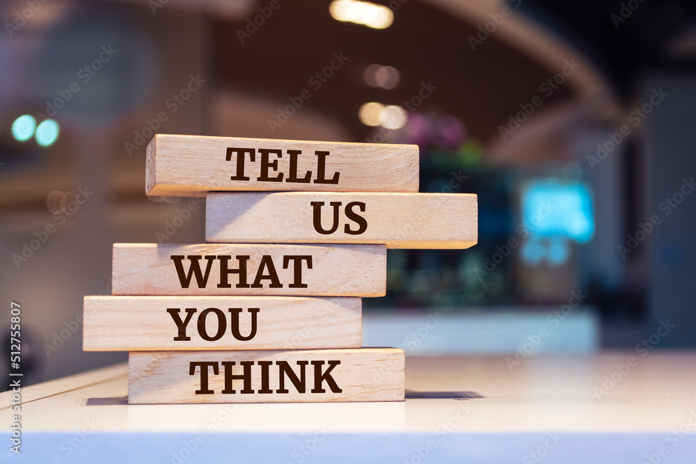 Wooden blocks with words 'Tell Us What You Think'. Business concept