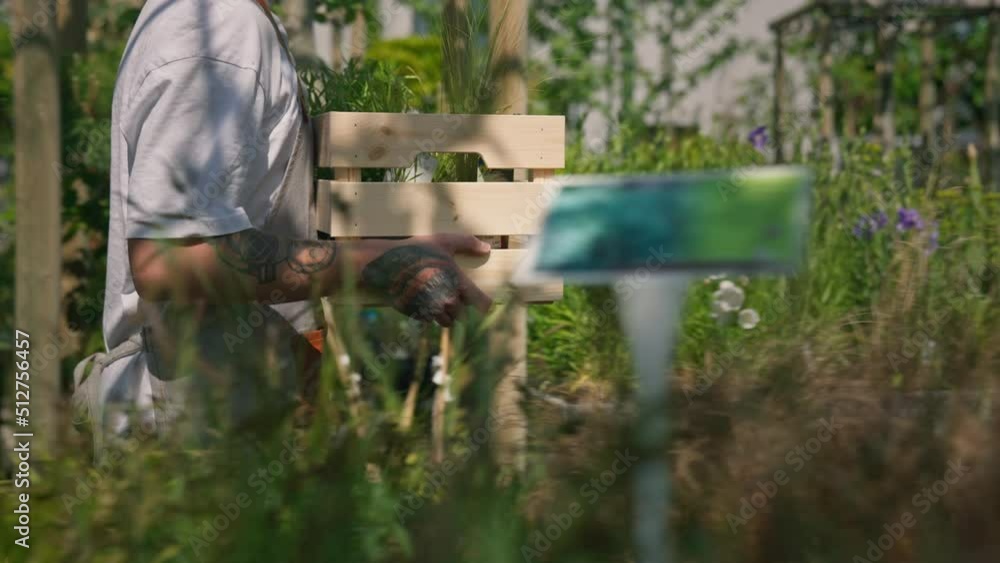 Portrait of colleagues in garden centre. Garden workers in aprons are looking at camera. Portrait of colleagues in garden centre. Garden workers in aprons are looking at camera.