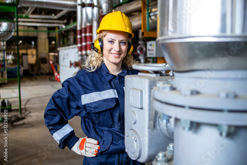 Tableau sur toile Portrait of female worker standing in boiler room of heating plant