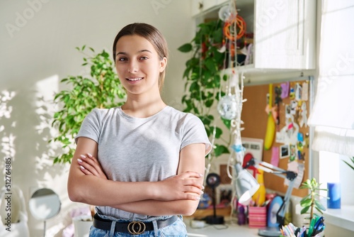 Fototapeta Naklejka Na Ścianę i Meble -  Portrait of smiling teenager girl 14, 15 years old looking at camera, at home in room