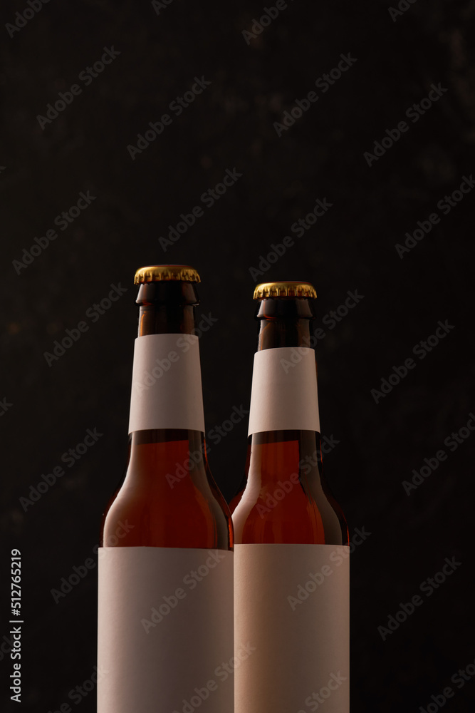 Two bottle of beer on on black background.