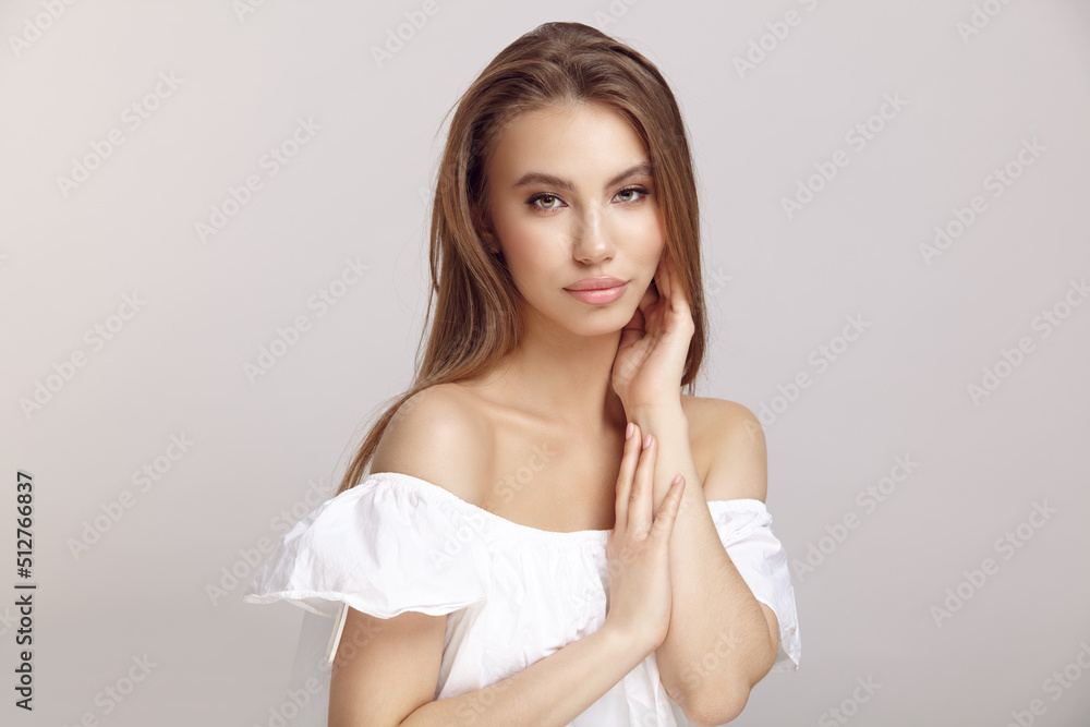 Young woman in stylish dress looks at camera in studio Young woman in stylish dress looks at camera in studio