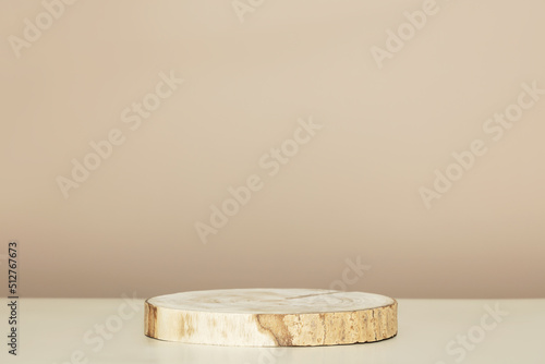 Fototapeta Naklejka Na Ścianę i Meble -  Wood slice podium on beige background for cosmetic product mockup