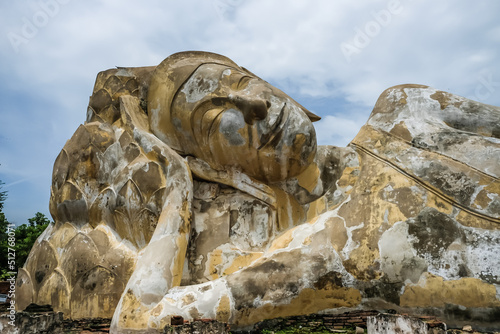 Lotus flowers supporting the reclining Buddha's head at Wat Lokaya Sutha,Phra Nakorn Sri Ayutthaya,Thailand.UNESCO World Heritage Site photo