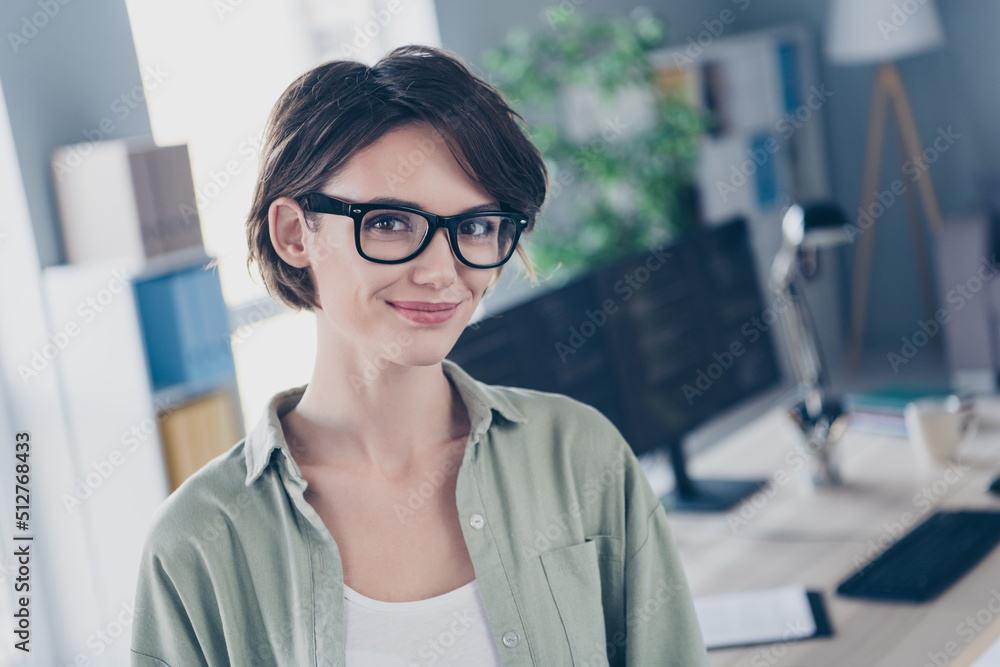 Photo of positive charming lady web designer look camera have good mood office light room indoors Photo of positive charming lady web designer look camera have good mood office light room indoors