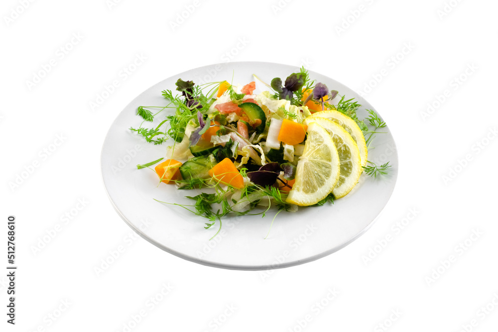 Vegetable salad with greens and pumpkin on a white plate on an isolated background, bright summer vegetables Vegetable salad with greens and pumpkin on a white plate on an isolated background, bright summer vegetables