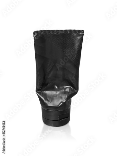 black plastic squeezed tube. Packaging for cosmetics on a white background