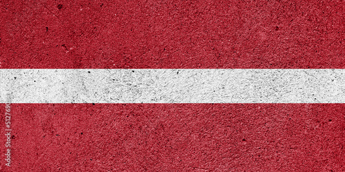 National flag of Latvia on a plastered wall
