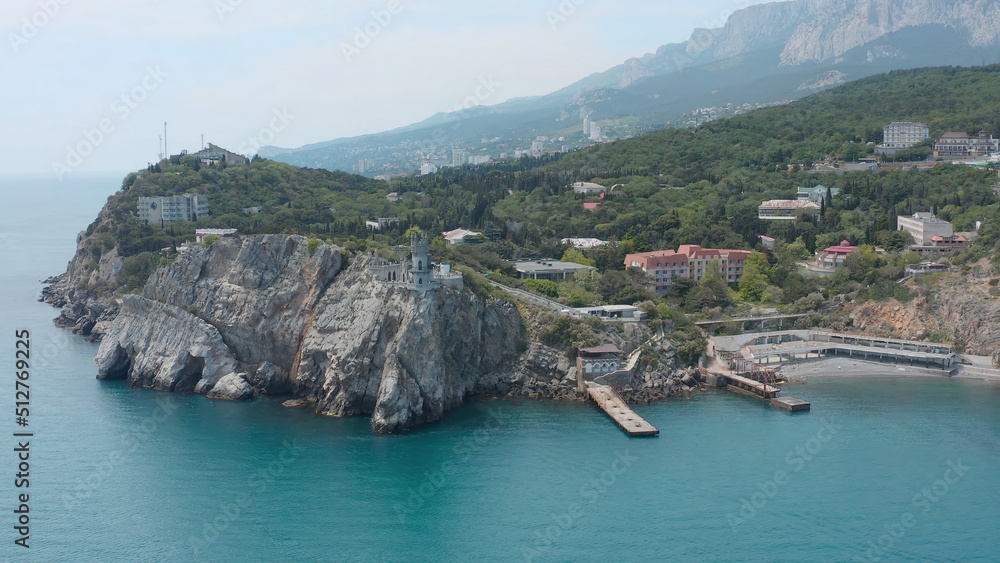 Beautiful bay with blue water and old town. Action. Top view of beautiful bay with seaside town and steep cliffs. Beautiful coast to south of Crimea