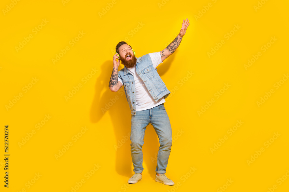 Full length photo of overjoyed chilling person enjoy listen favorite song isolated on yellow color background Full length photo of overjoyed chilling person enjoy listen favorite song isolated on yellow color background
