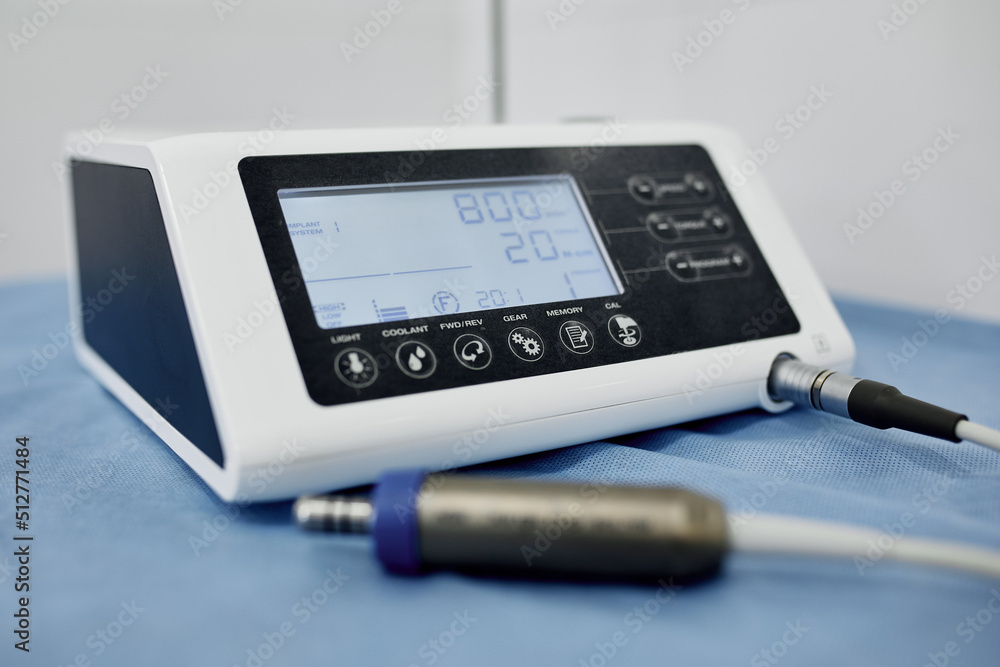 Dental equipment in the office of a dentist doctor with gray walls against the backdrop of bright light from the window. Dental equipment in the office of a dentist doctor with gray walls against the backdrop of bright light from the window.