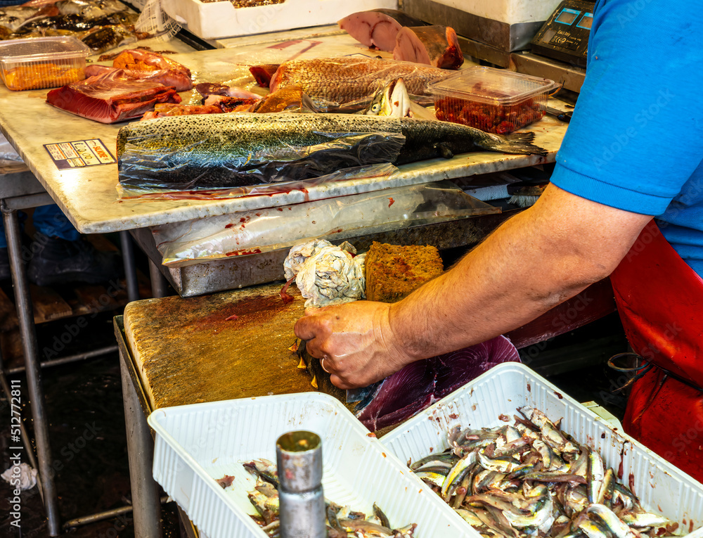 cook on fish kitchen , lifestyle of a marine restaurant worker closeup cook on fish kitchen , lifestyle of a marine restaurant worker closeup