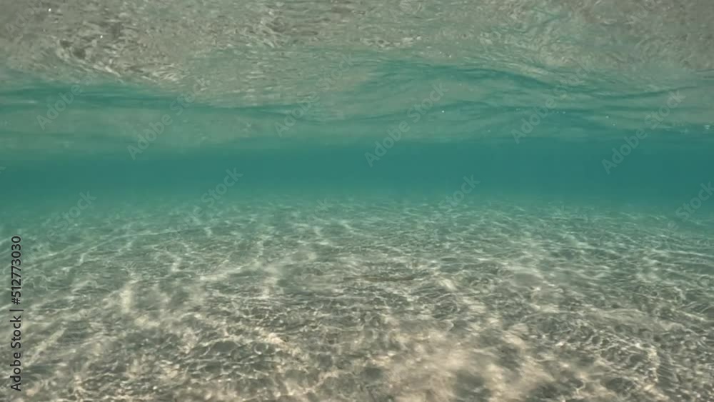 Underwater slow motion loop video of beautiful exotic turquoise sandy sea bed as seen in tropical paradise destination island Underwater slow motion loop video of beautiful exotic turquoise sandy sea bed as seen in tropical paradise destination island