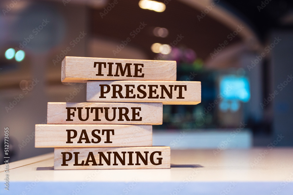 Wooden blocks with words 'time, present, future, past, planning'. Time concept